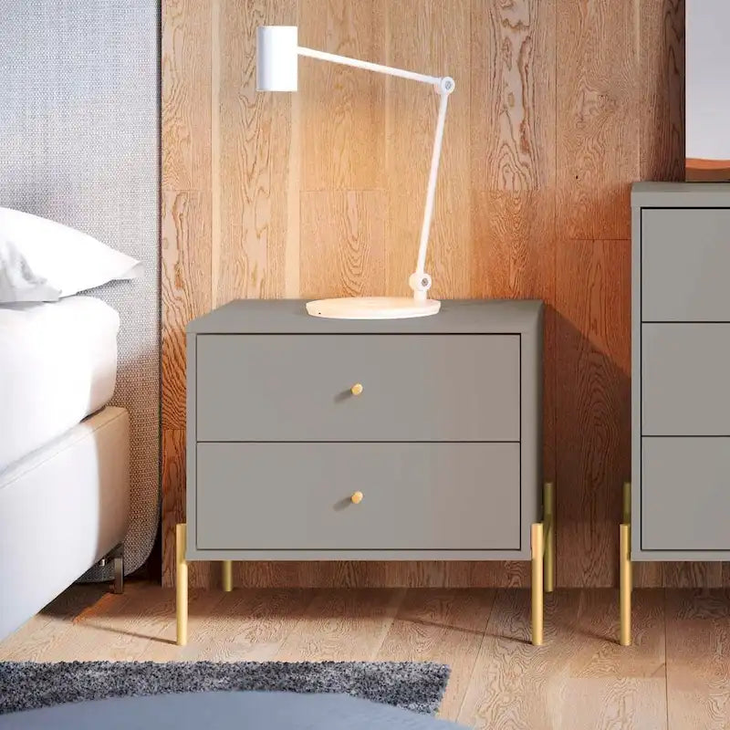 Bedside table with gold steel legs and a white glossy finish.
