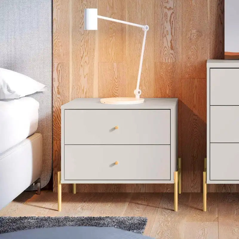 Bedside table with gold steel legs and a white glossy finish.